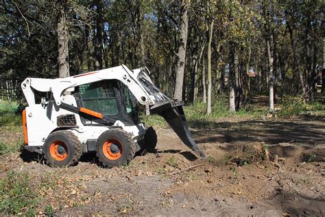 will a skid steer dig|skid steer lawn digging.